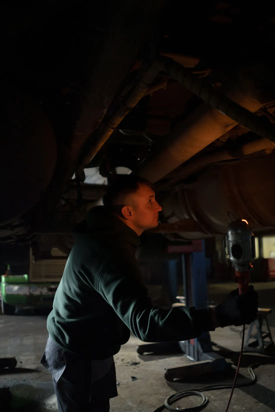 Illustrative raised vehicle in a workshop